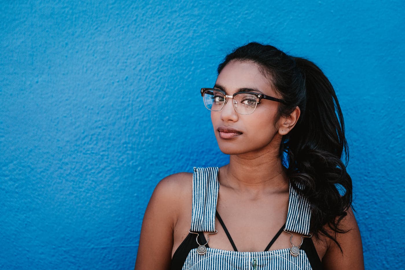 A woman wearing half-rim cat-eye glasses