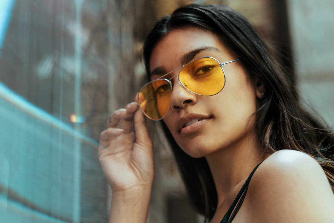 A woman wearing yellow tinted glasses